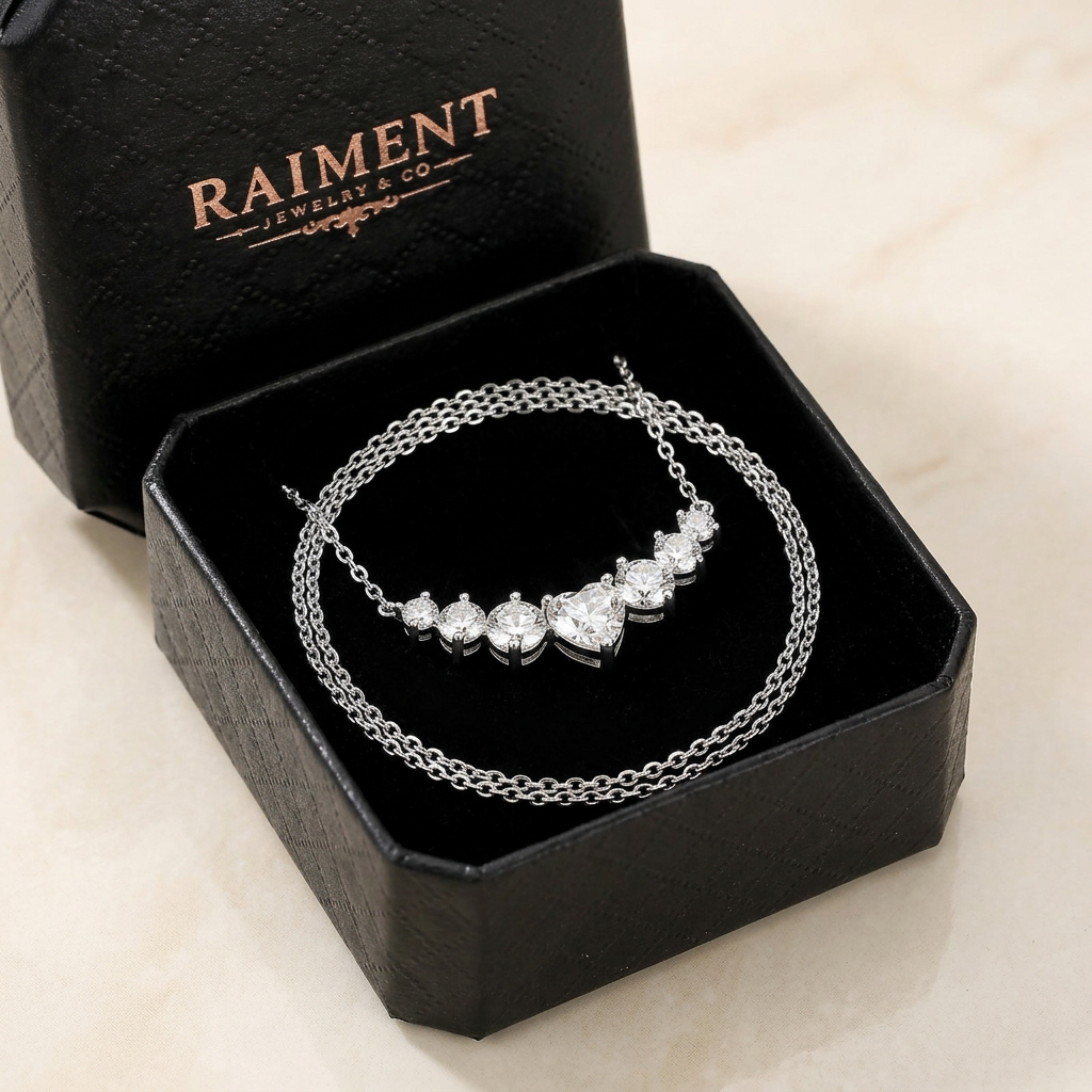 Moissanite graduated cluster necklace inside open jewelry box, Raiment Jewelry & Co.