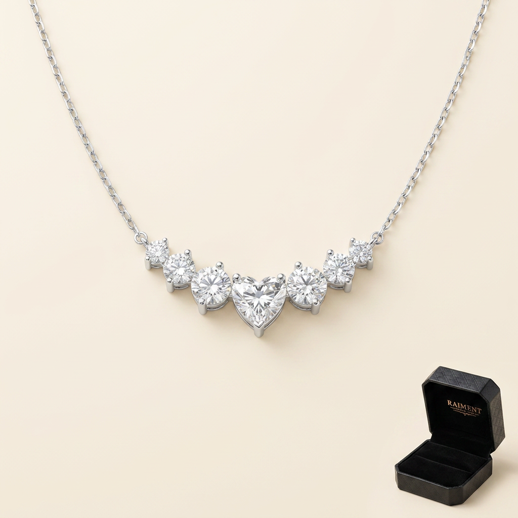 Moissanite graduated cluster necklace on cream background, Raiment Jewelry & Co.