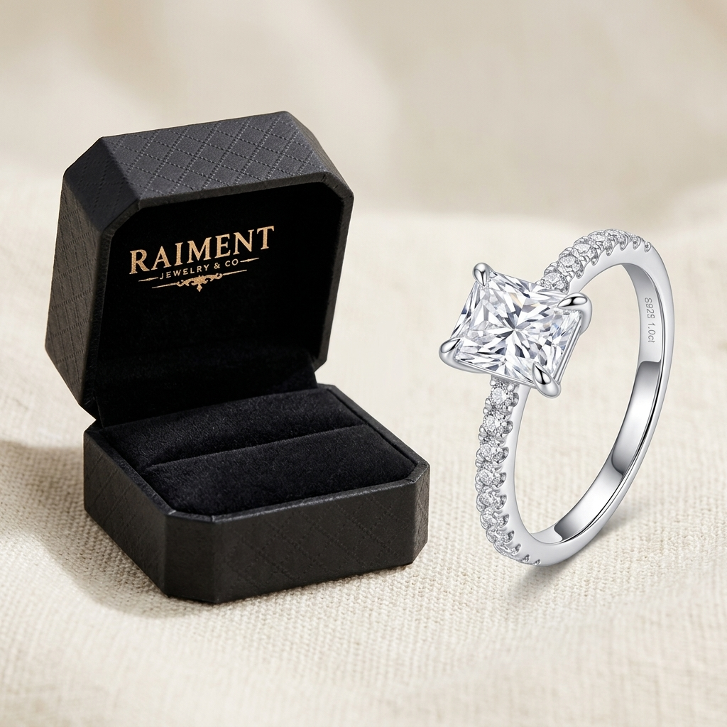 Raiment Jewelry & Co. moissanite twist accent band ring beside open jewelry box on cream background