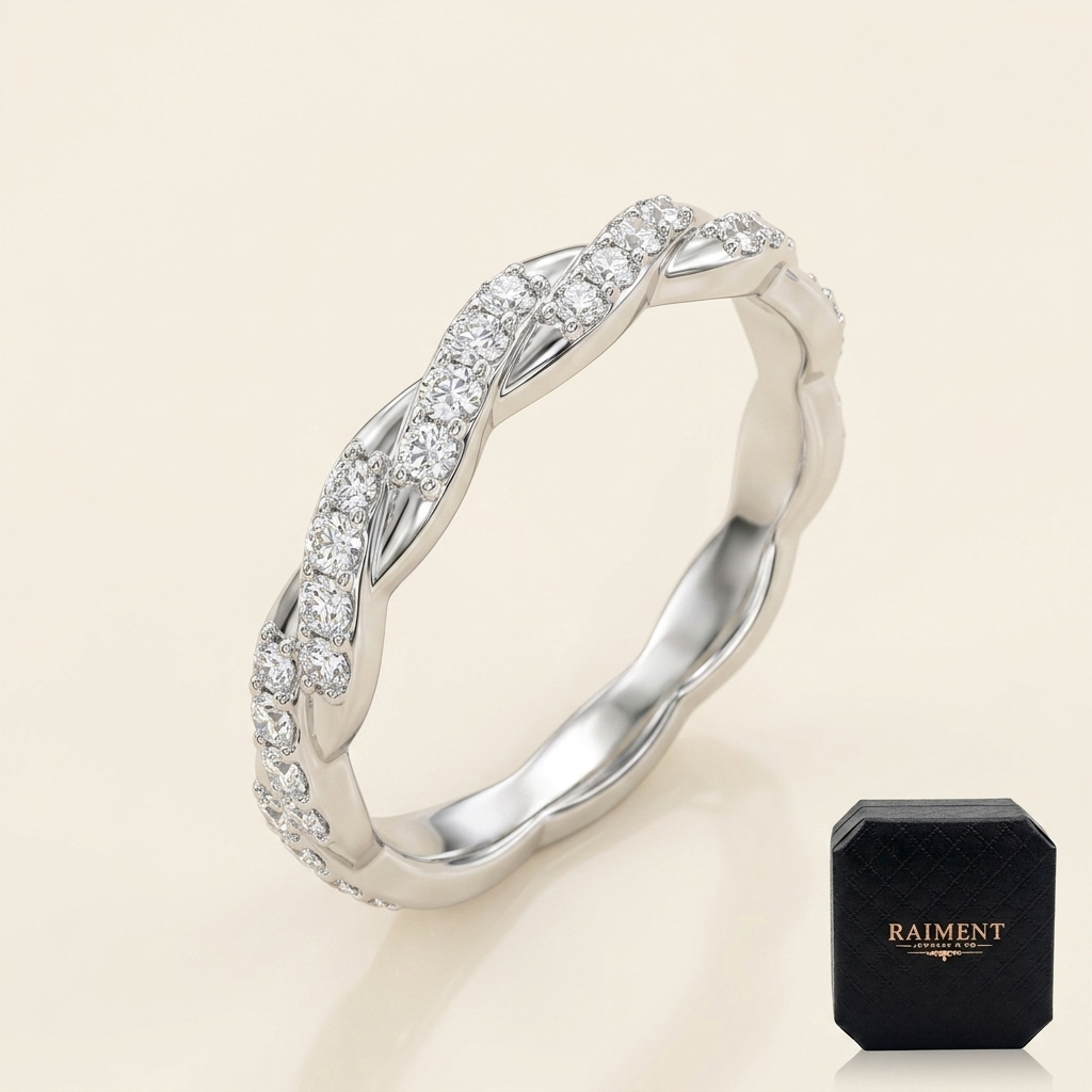 Moissanite twist accent band ring on cream background, Raiment Jewelry & Co.
