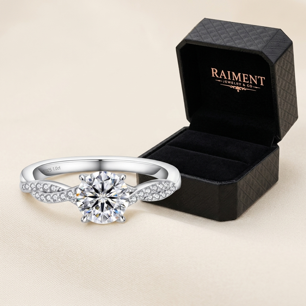 Raiment Jewelry & Co. moissanite 4-claw solitaire ring beside open jewelry box on cream background