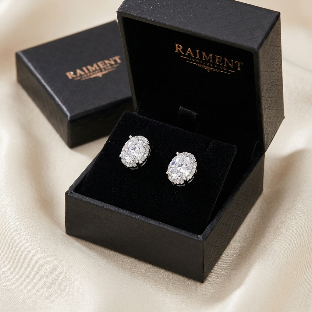 Moissanite oval halo stud earrings inside open jewelry box, Raiment Jewelry & Co.
