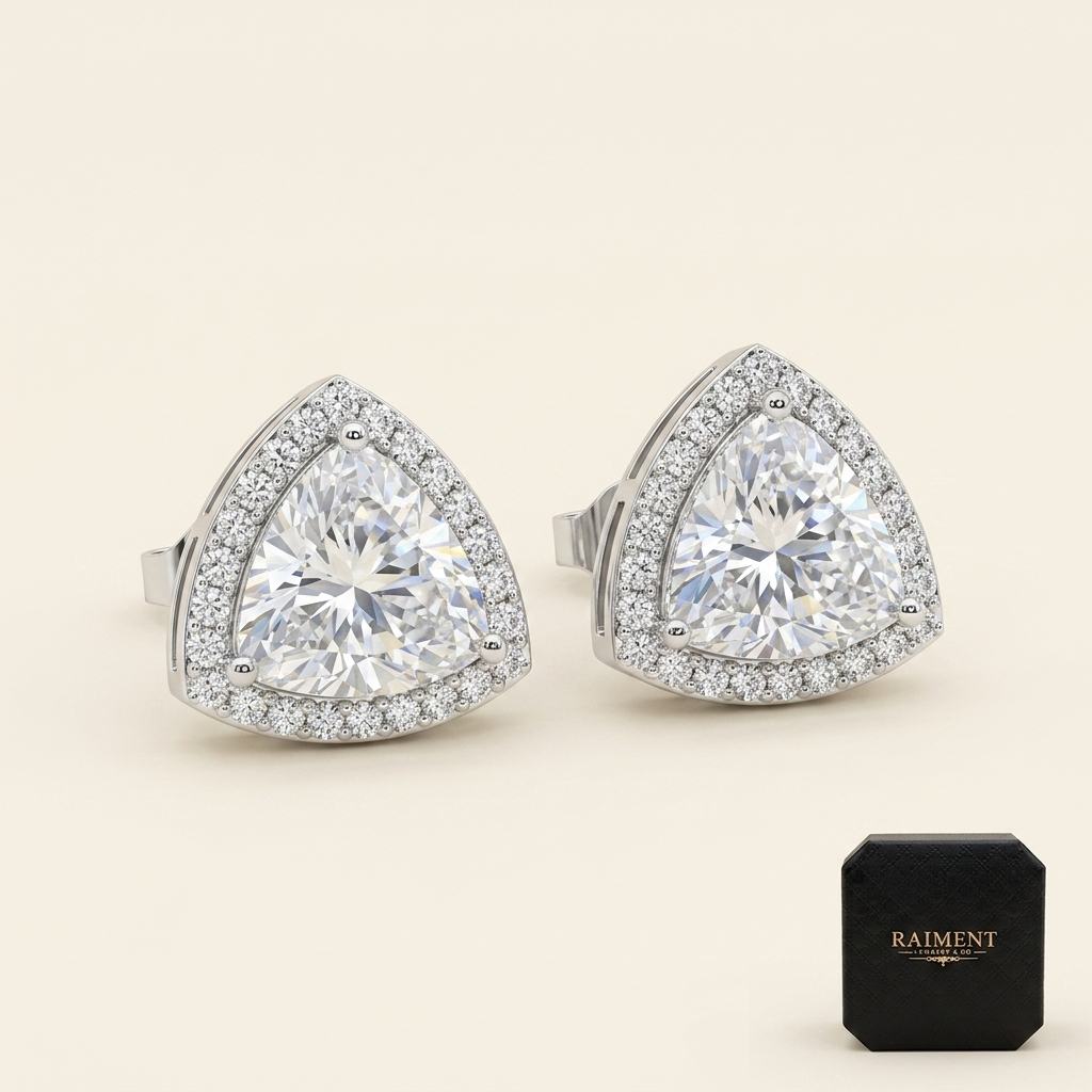 Moissanite trillion halo stud earrings on cream background, Raiment Jewelry & Co.
