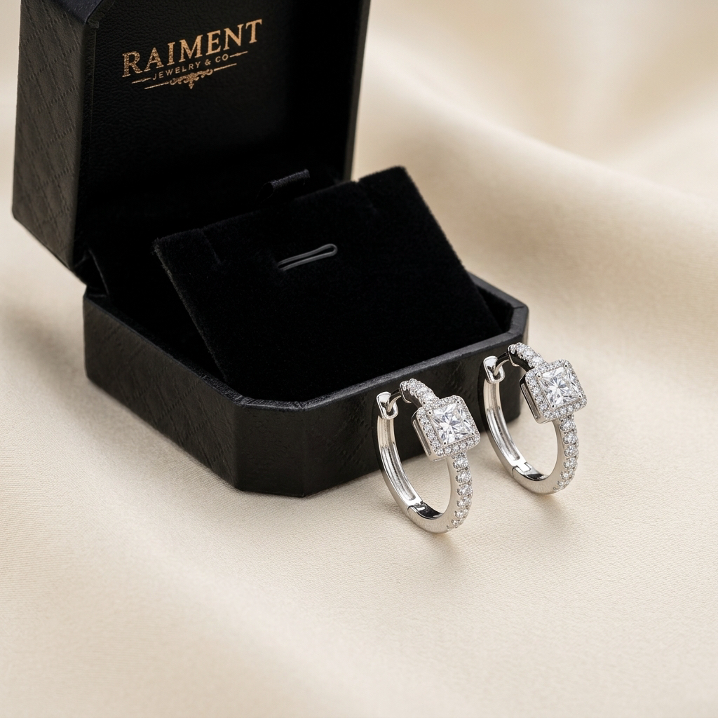 Moissanite pave hoop earrings 1ct styled beside jewelry box on cream, Raiment Jewelry & Co.