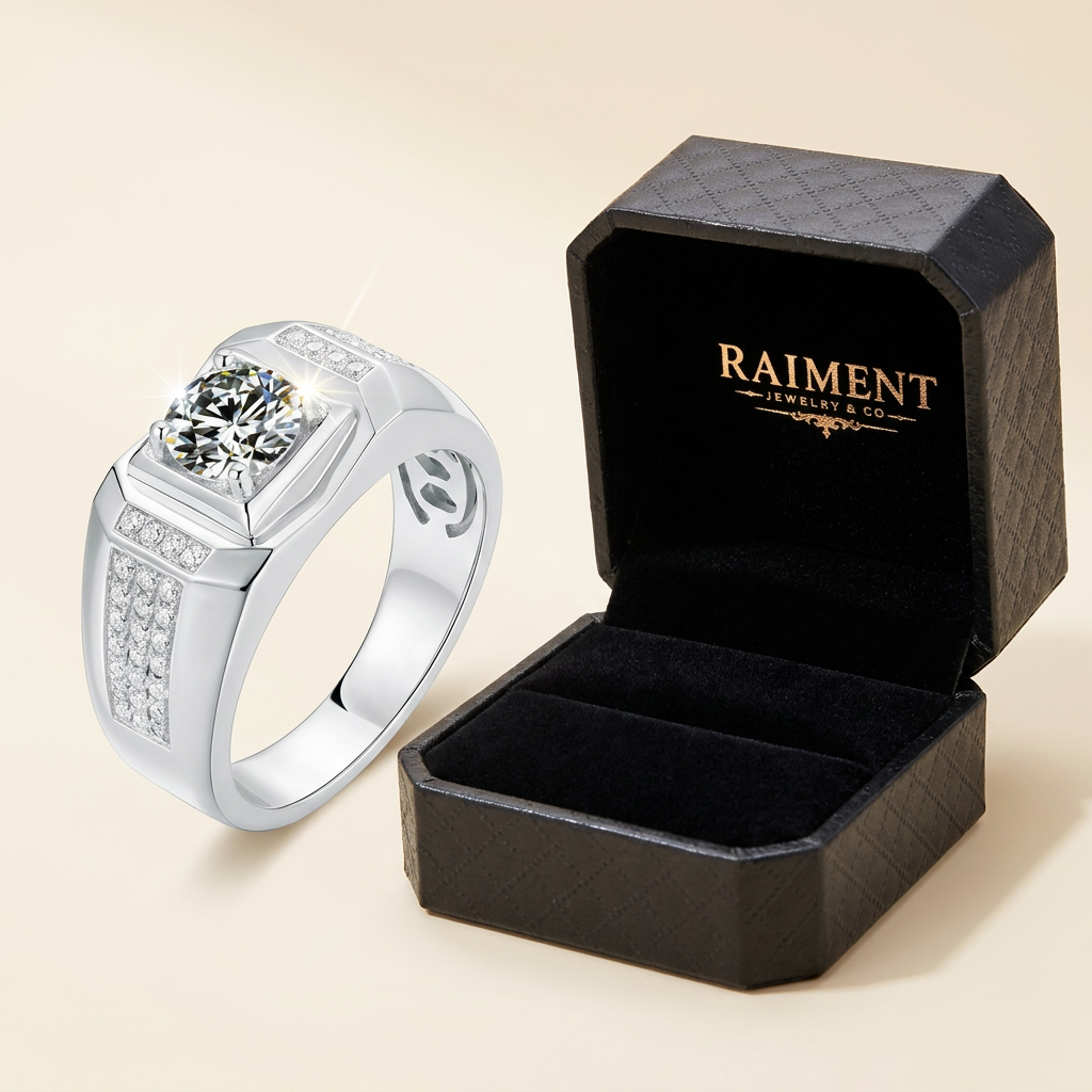 Raiment Jewelry & Co. men's moissanite signet ring beside open jewelry box on cream background