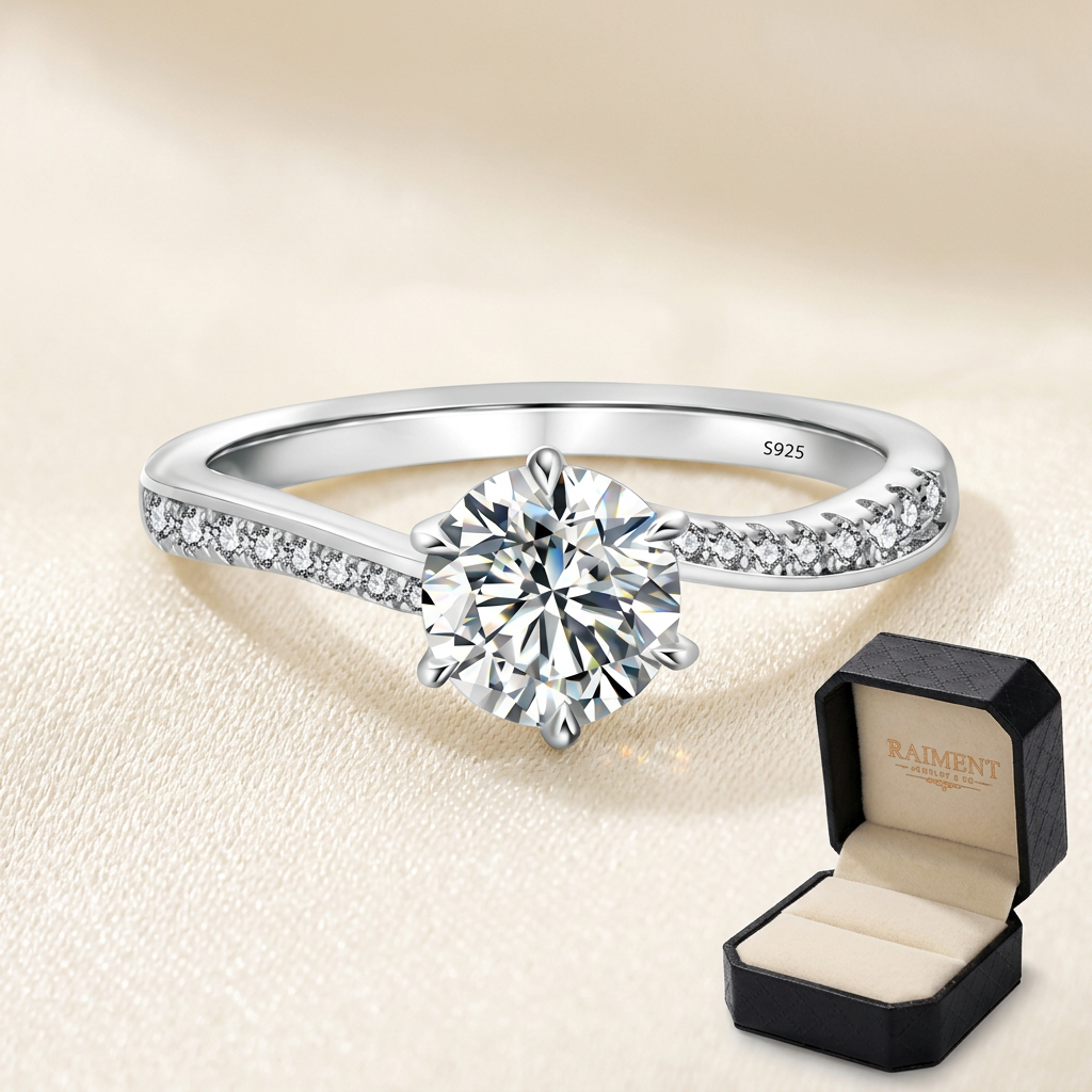 Women's moissanite three-stone ring on cream background, Raiment Jewelry & Co.
