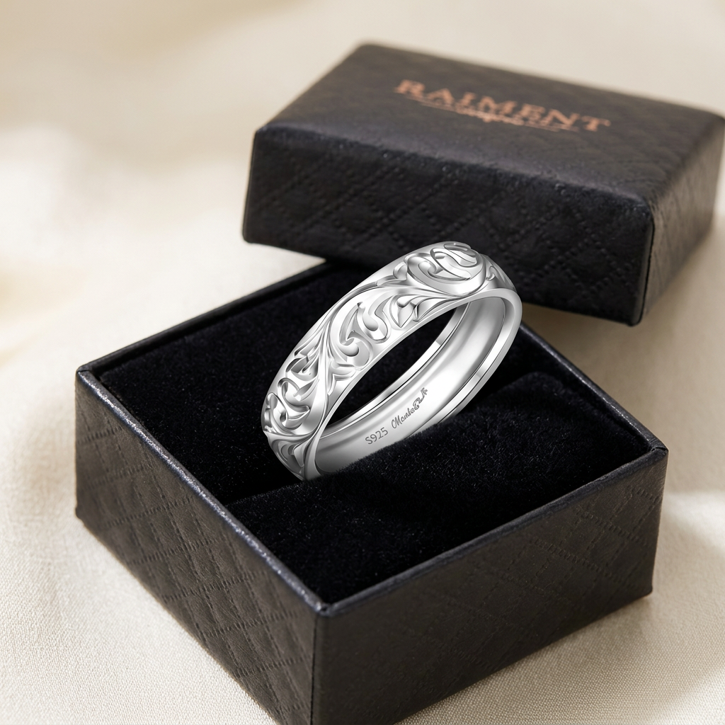 Moissanite four-claw solitaire ring inside open jewelry box, Raiment Jewelry & Co.