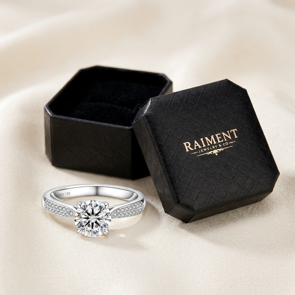 Raiment Jewelry & Co. moissanite pave shoulder ring beside open jewelry box on cream background