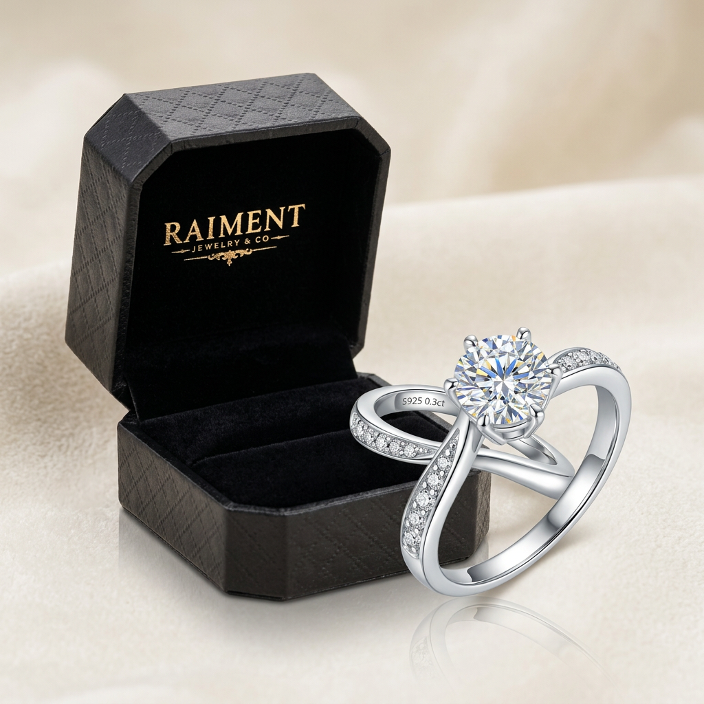 Raiment Jewelry & Co. moissanite wave accent ring beside open jewelry box on cream background