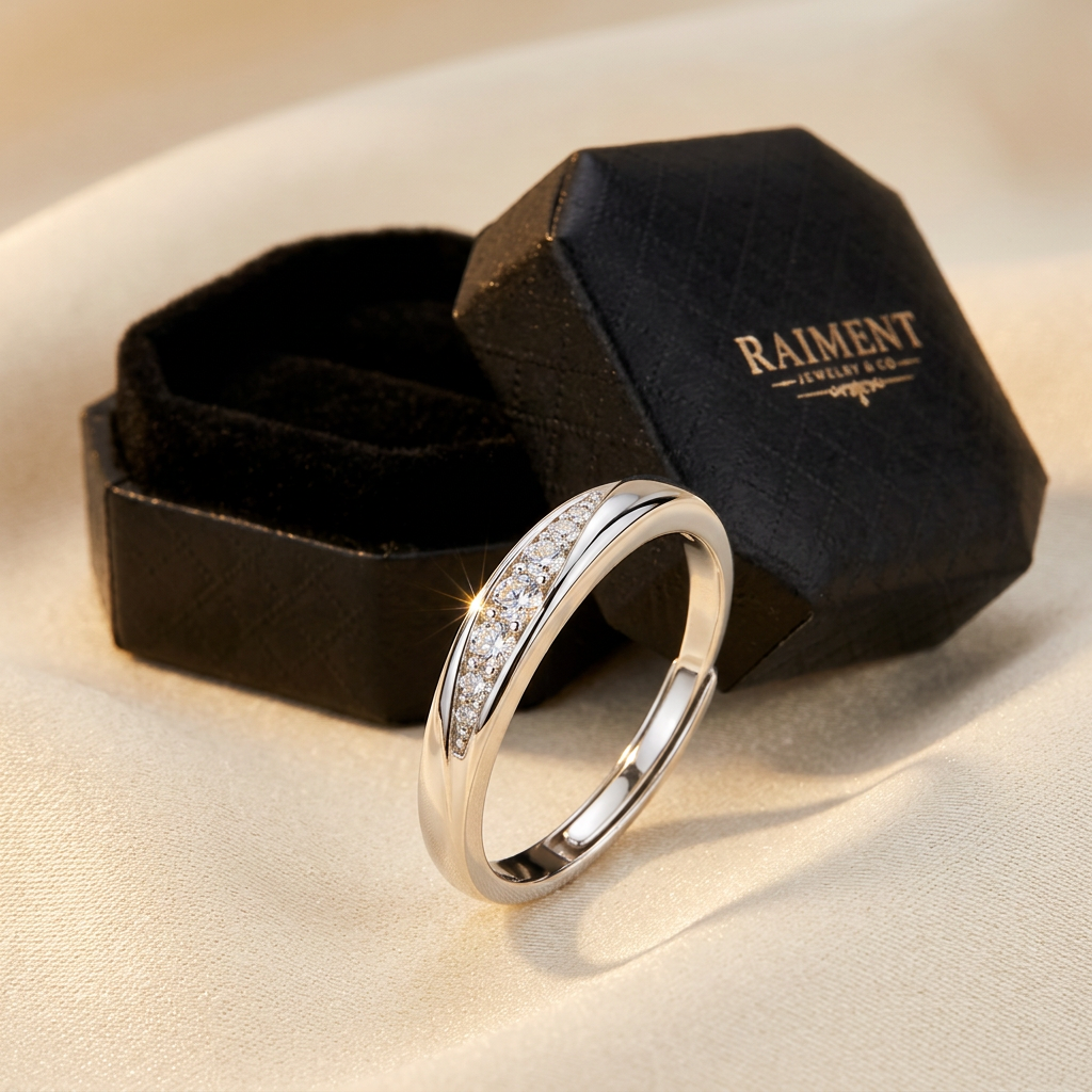 Adjustable moissanite wave ring styled beside jewelry box on cream, Raiment Jewelry & Co.