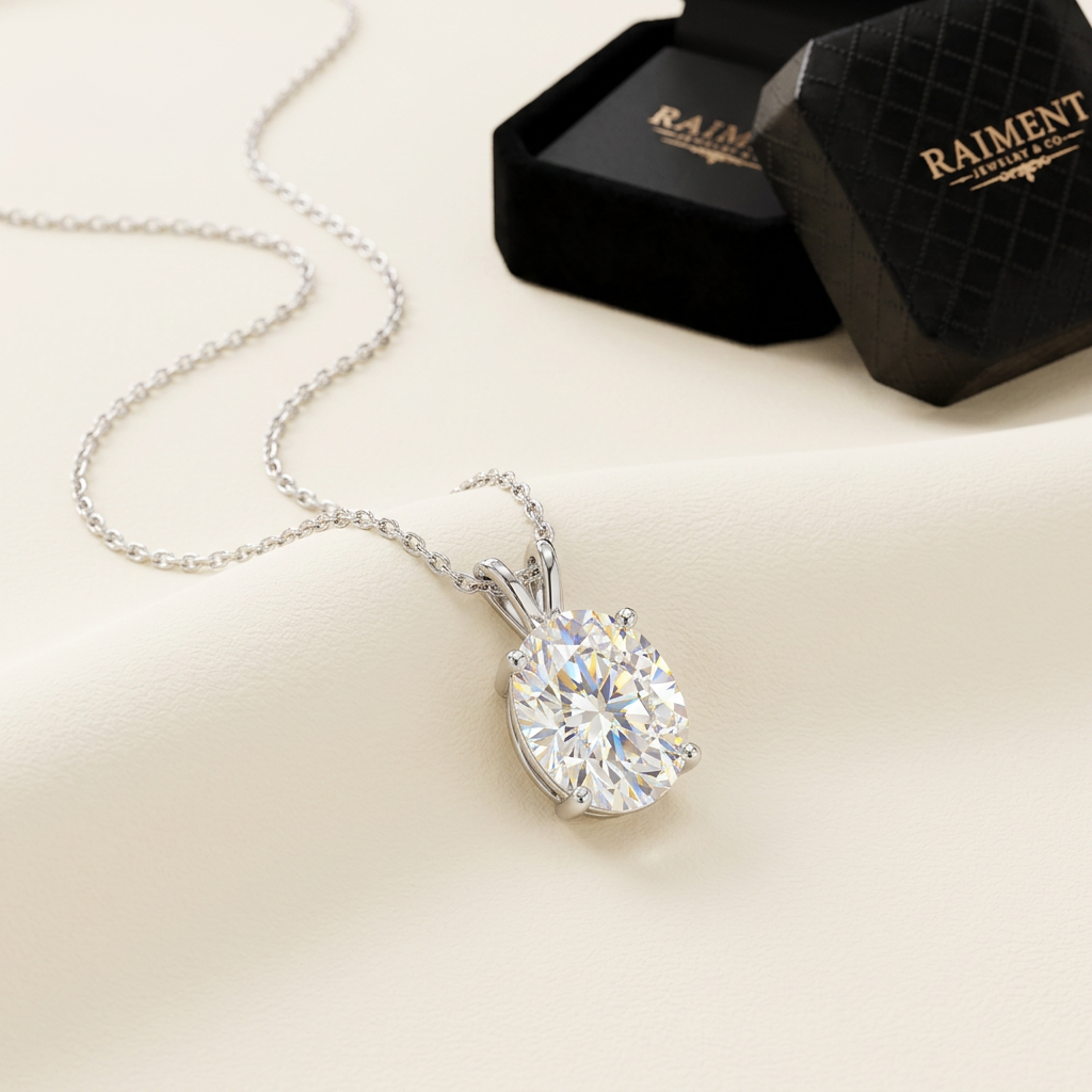 Oval cut moissanite pendant on cream background, Raiment Jewelry & Co.